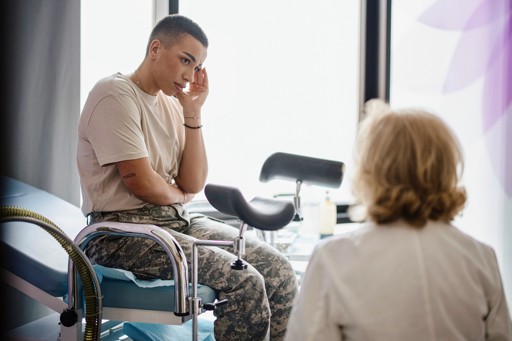 Image of woman sat with a doctor in exam room