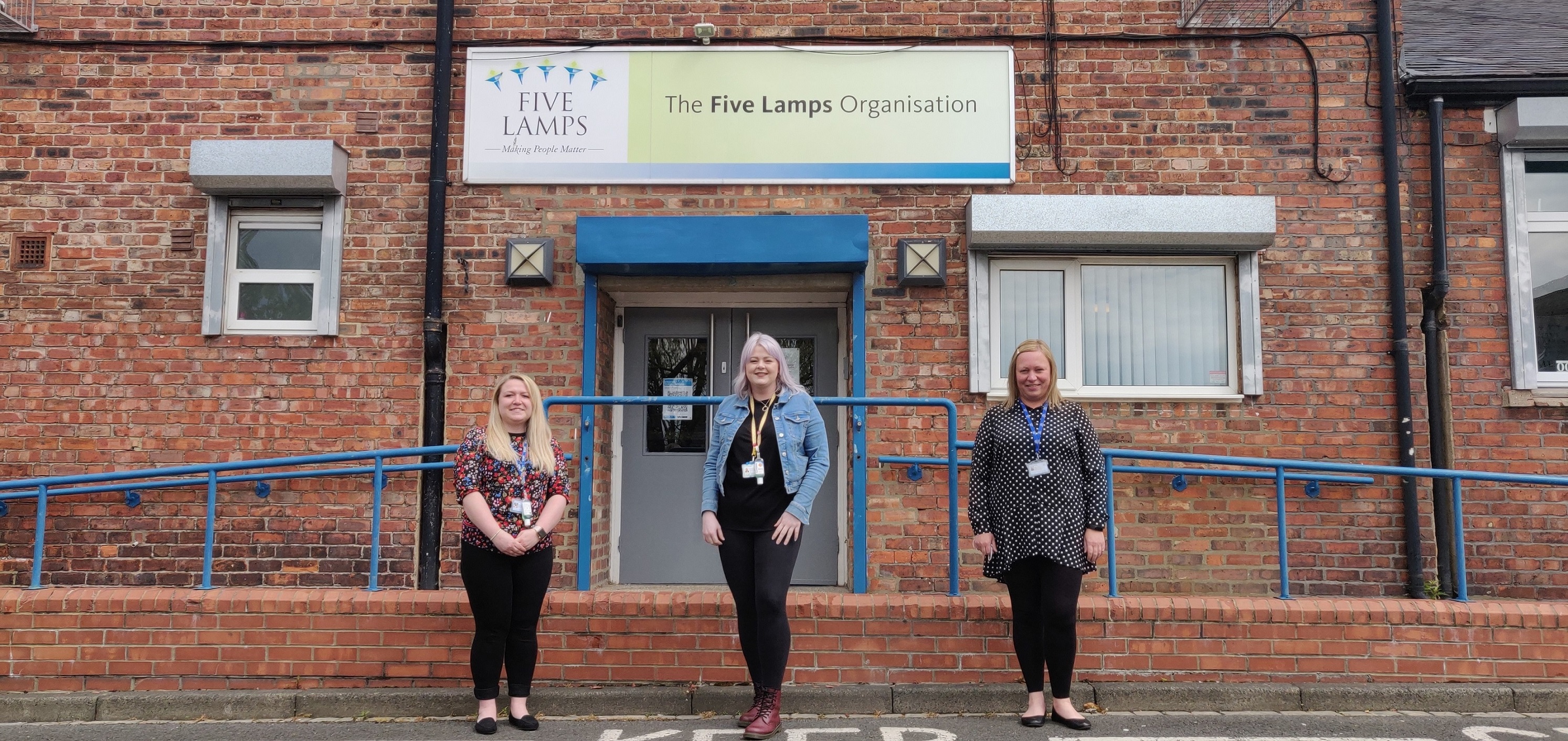 Image of three women stood outside Five Lamps community organisation in Thornaby