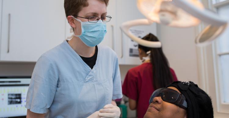Image of dentist treating a member of the public