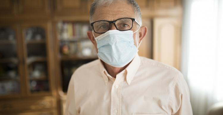Image of man in a care home wearing a mask