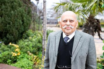 Elderly gentleman standing in a courtyard