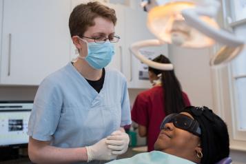 Image of dentist treating a member of the public