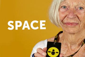 Image of woman holding lanyard for ‘Please give me space' campaign