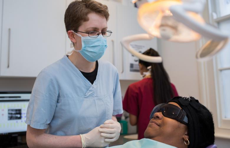 Image of dentist treating a member of the public